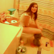 A very brief video clip of a brunette girl pooping on a toilet.